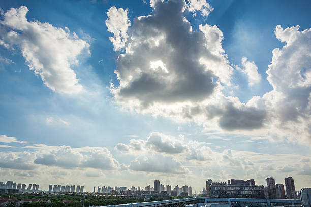 Stunning City Skyline Under a Vast Sky with Dramatic Clouds and Sunlight