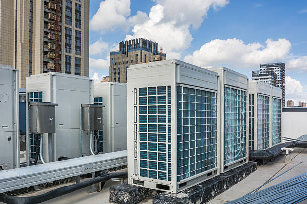 istock Modern Rooftop Air Conditioning Units Against a City Skyline 2214041724