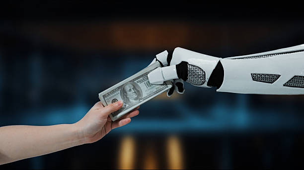 istock Robot hand giving cash to human hand, representing interaction between technology and finance in a modern digital economy, showcasing automation and investment 2214044948