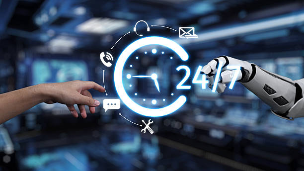 istock Human touch and AI support represented by hand reaching out to robotic arm with glowing digital clock symbolizing 24-hour availability in high-tech environment. Auvana 2214045722