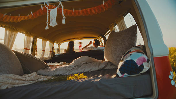 istock Two Women Relaxing in their Campervan at Sunset 2214045804