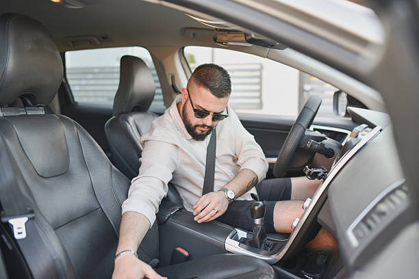 istock Focused Male Driver Adjusting Passenger's Car Seat Before Picking Up Friend 2214047001