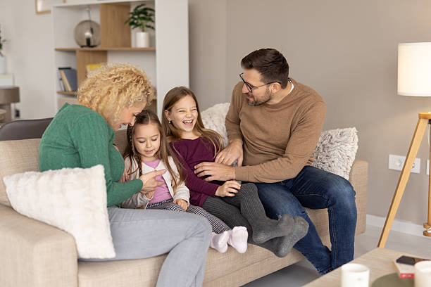 istock Siblings share laughter and warmth with their parent. 2214048102