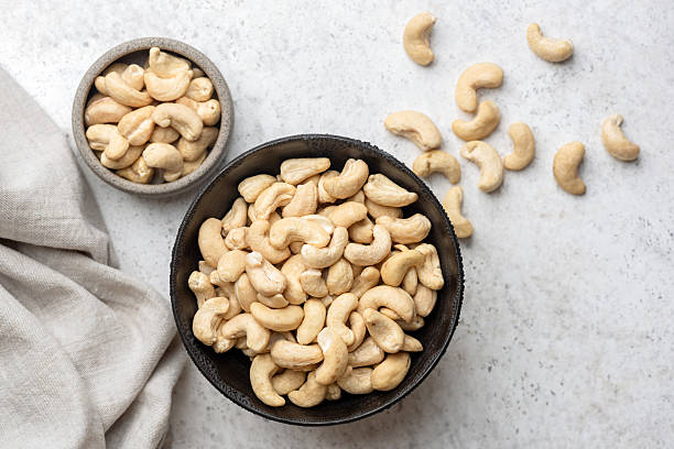 istock Dry unshelled cashew nuts in bowl 2214049516