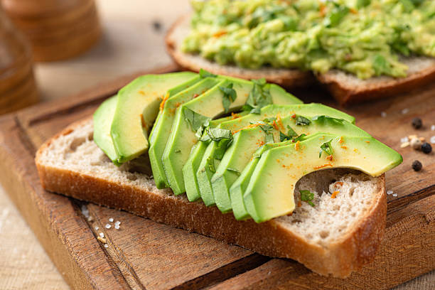 istock Healthy avocado toast on wooden board 2214049547