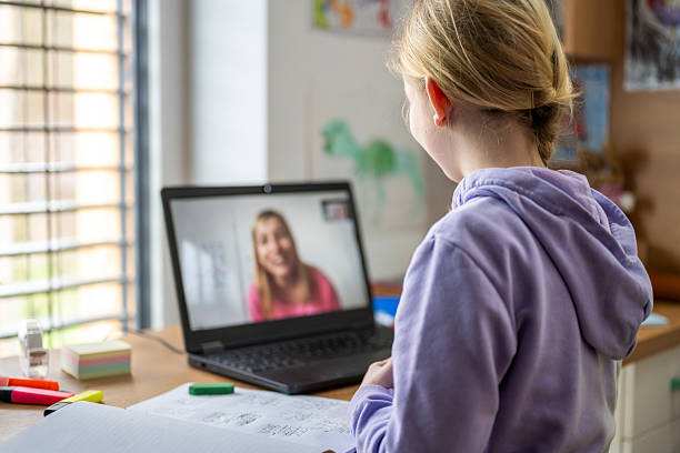 istock Girl Smiling During Online Lesson with Teacher 2214049866
