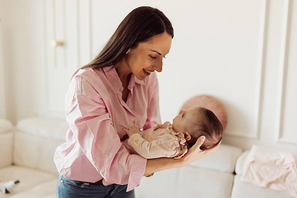 istock Mom Cradling Infant Daughter 2214050404