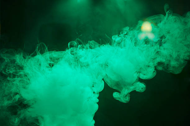 istock Smoke in a dark room in colored rays 2214052399