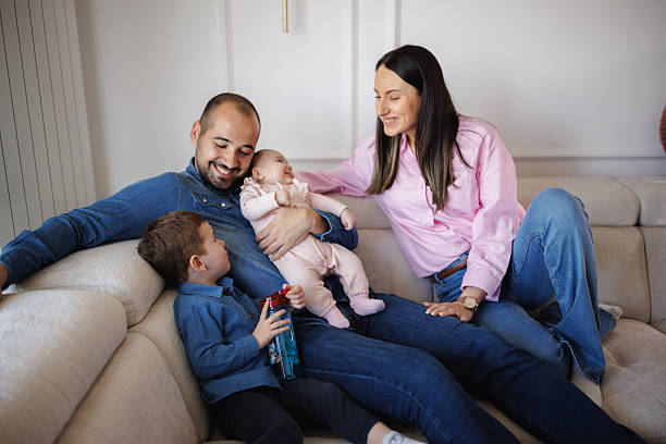 istock Happy Family Relaxing on Sofa at Home 2214052462