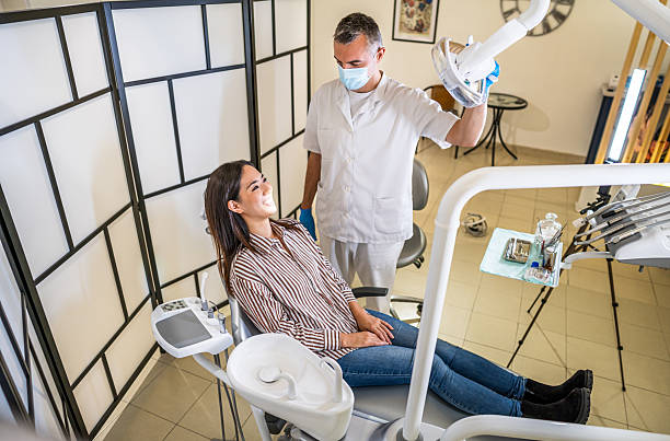 istock Dentist positioning dental x-ray equipment over patient 2214056022