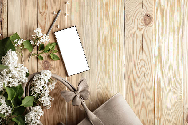 Spring Composition – Flat Lay of Purse, Flowers and Smartphone. Copy space for text.