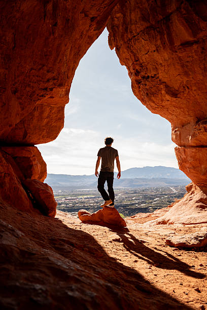 istock A man standing and looking out from Scout Cave over St. George, Utah. 2214061331