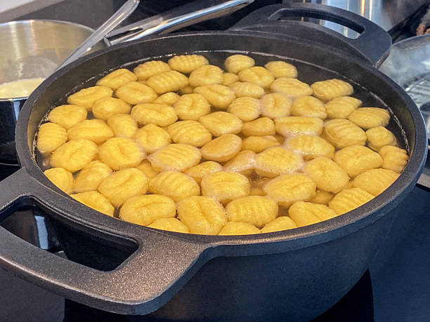 High angle close-up view of boiling gnocchi in domestic kitchen