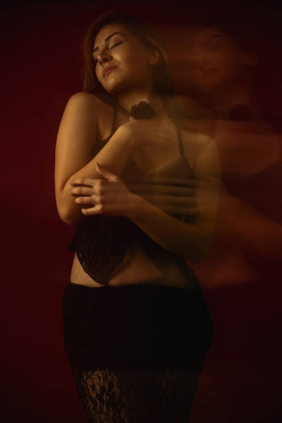 istock Gorgeous Female Posing Seductively Embracing Herself With Closed Eyes 2214063214