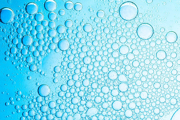 istock Macro blue science experiment bubble texture,A close-up of a blue liquid with bubbles in a petri dish, showcasing a captivating microscopic view. ideal for concepts of science, medicine, research, 2214063689
