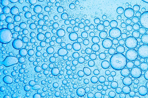 istock Macro blue science experiment bubble texture,A close-up of a blue liquid with bubbles in a petri dish, showcasing a captivating microscopic view. ideal for concepts of science, medicine, research, 2214063692
