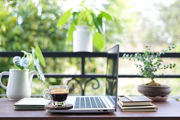 istock chilling balcony workspace with coffee drink and laptop side view 2214069665