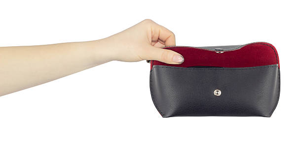 istock glasses case in hand, outstretched hand with leather glasses case, isolated from background 2214070090