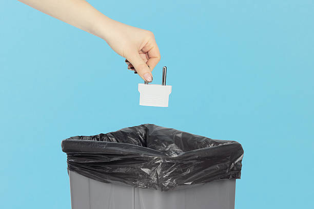 istock throwing adapter for American outlet into trash, outstretched hand with plug adapter in front of trash can 2214070201