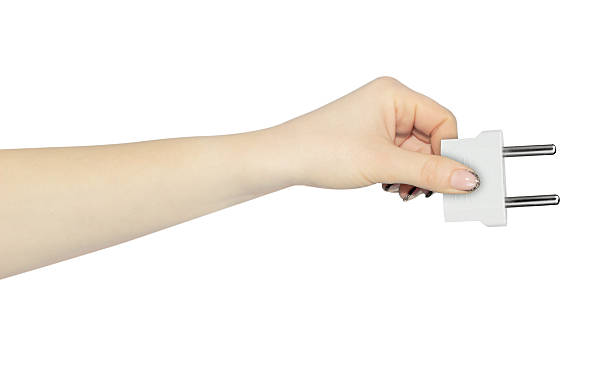 istock adapter for American outlet in hand, outstretched hand with plug adapter, isolated from background 2214070397