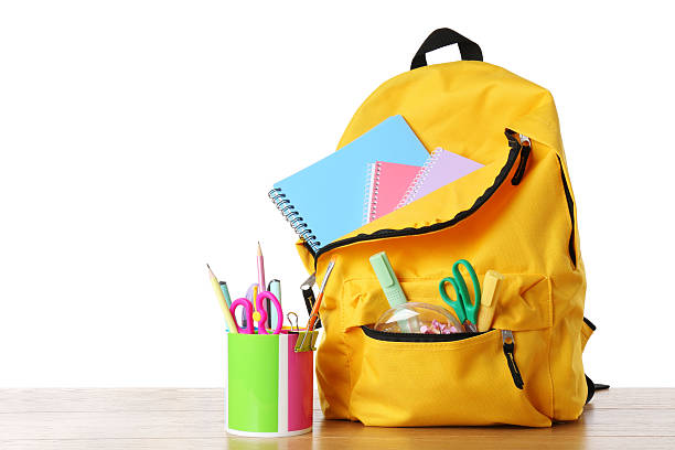 istock Backpack with different school stationery on wooden table against white background, space for text 2214072533