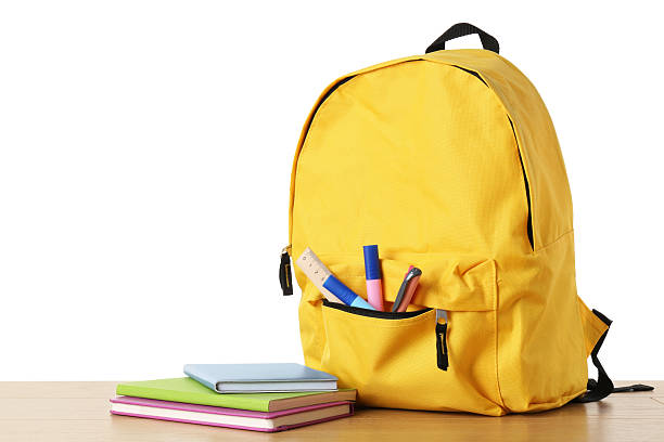 istock Backpack with different school stationery on wooden table against white background 2214072547