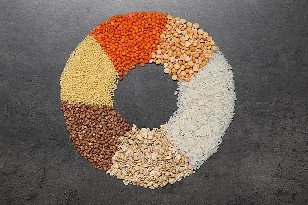 istock Different types of cereals and legumes on grey table, top view 2214072661