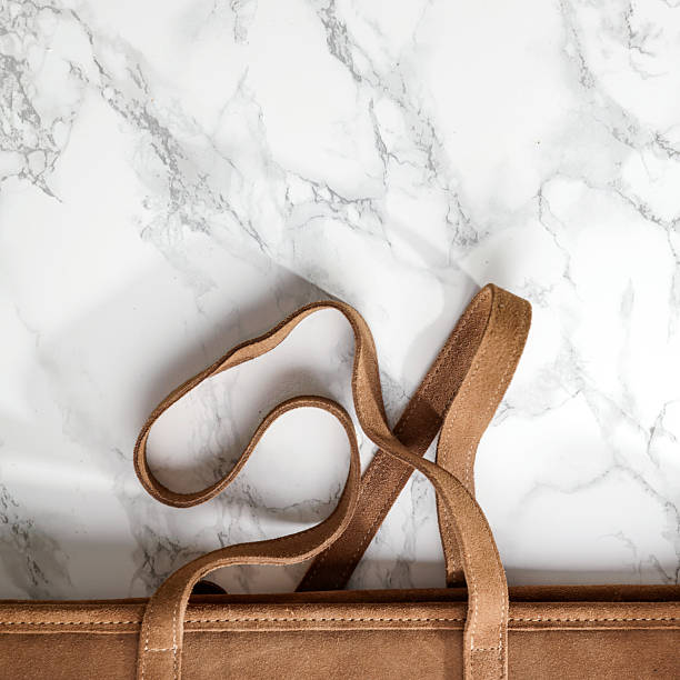 istock Elegant flat lay with brown bag on white marble background - romantic female composition with blank copy space for text or product. Perfect for design project. 2214072881