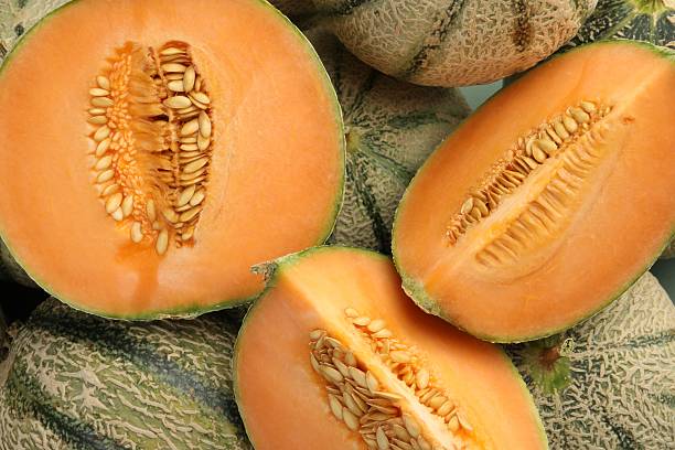 istock Many ripe Cantaloupe melons as background, top view 2214073083