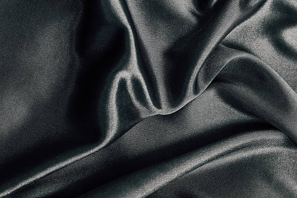 istock Elegant dark fabric draped softly on a smooth surface for textile design and inspiration 2214074944
