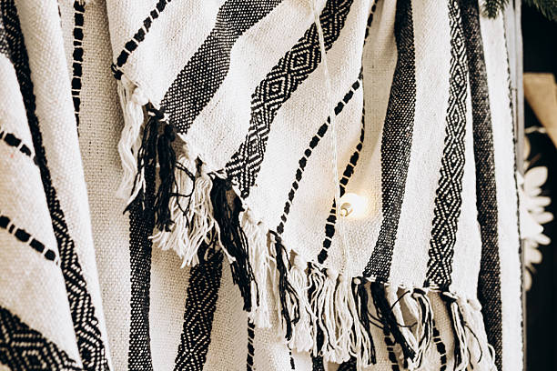 istock Handwoven textile with black and white patterns hanging in a craft store during daytime 2214075069