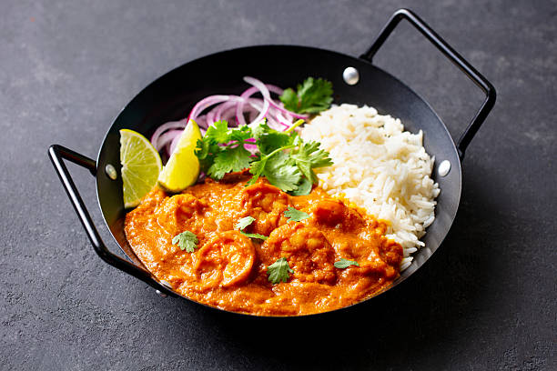 istock Spicy Shrimp Curry with Rice and Garnish. Grey background. Close up. 2214076319