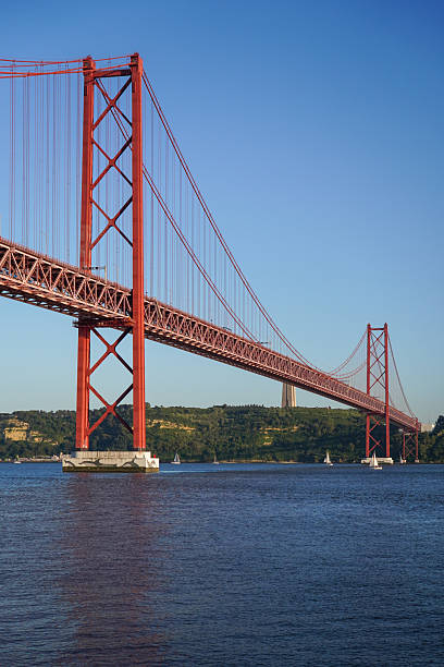 istock Iconic Red Suspension Bridge Spanning River Boats Clear Sky Lisbon 2214078662