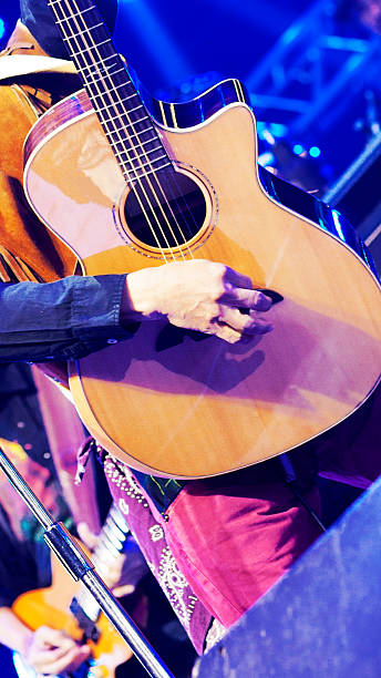 istock Guitarist plays guitar vertically 2214079310