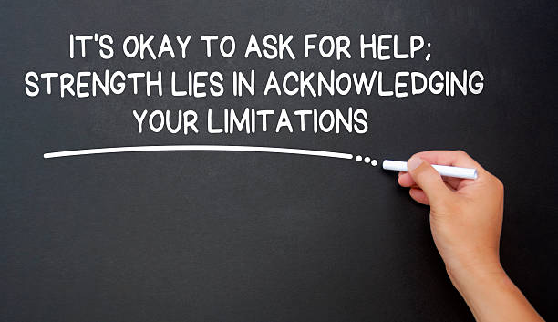 istock It is okay to ask for help, strength lies in acknowledging your limitations text written on black board. Inspirational and motivational concept. 2214079627