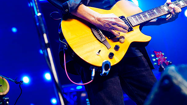 Rock guitarist in blue stage lights
