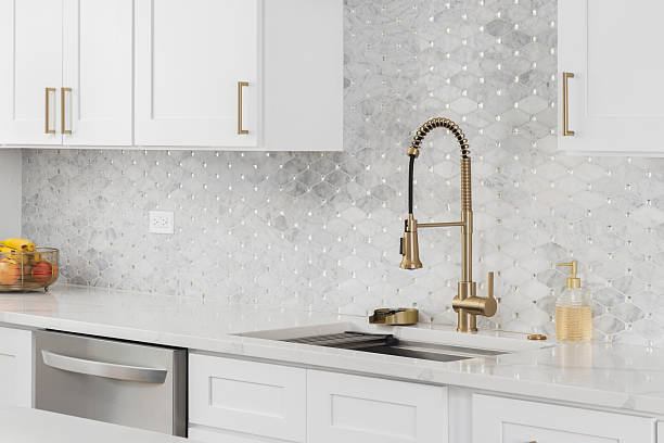 istock A gold faucet kitchen detail in a while kitchen. 2214081679