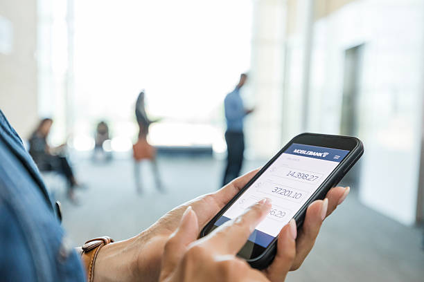 istock Woman Using Mobile Banking App on Smartphone 2214081789