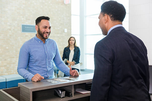 istock Friendly Businessmen Talking at Reception Desk 2214081840
