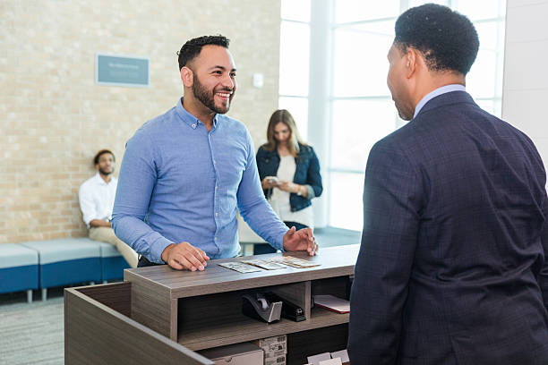 istock Friendly Businessman and Client Talking in Office Lobby 2214081841