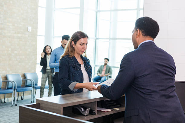 istock Woman handing document to businessman at office reception 2214081845