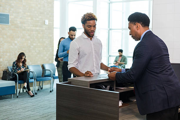 istock African-American Man Paying at a Business Reception Desk 2214081861