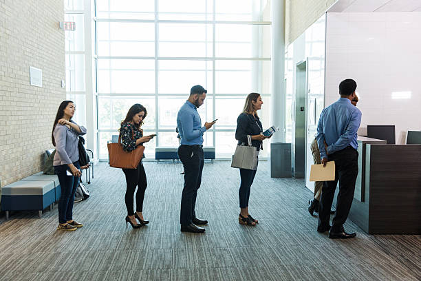 istock Diverse Group of People Waiting in Line Indoors 2214081880