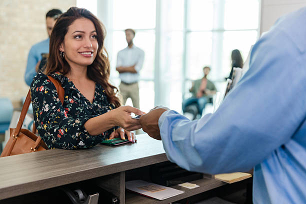 istock Woman Paying at Reception Desk with Credit Card 2214081897