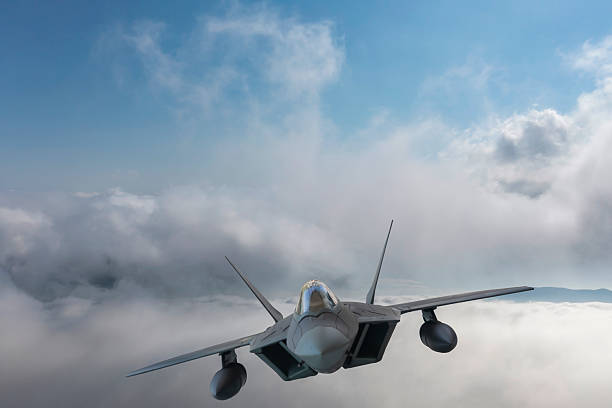 istock F-22 jet aircraft flying over clouds. 2214082698