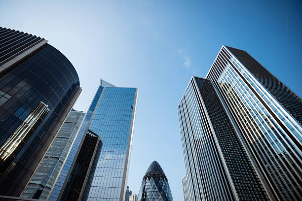 istock Modern skyscrapers in a city skyline featuring glass facades and distinctive architectural designs under a cloudy sky 2214084782