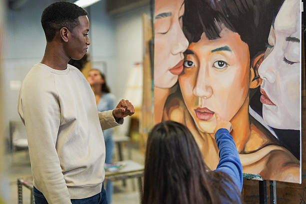 istock Multiracial students inside university art classroom - Young people painting on canvas - School concept 2214085873