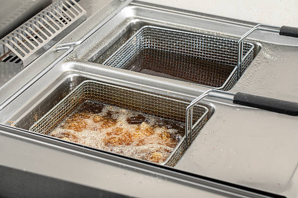 istock Frying golden chicken wings in deep fryer 2214090027