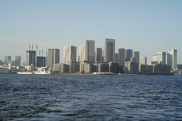 istock Modern Urban Skyline with Tall Buildings and Waterfront View Under Clear Blue Sky 2214093475