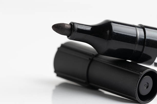 Closeup black marker pen isolated on white background.